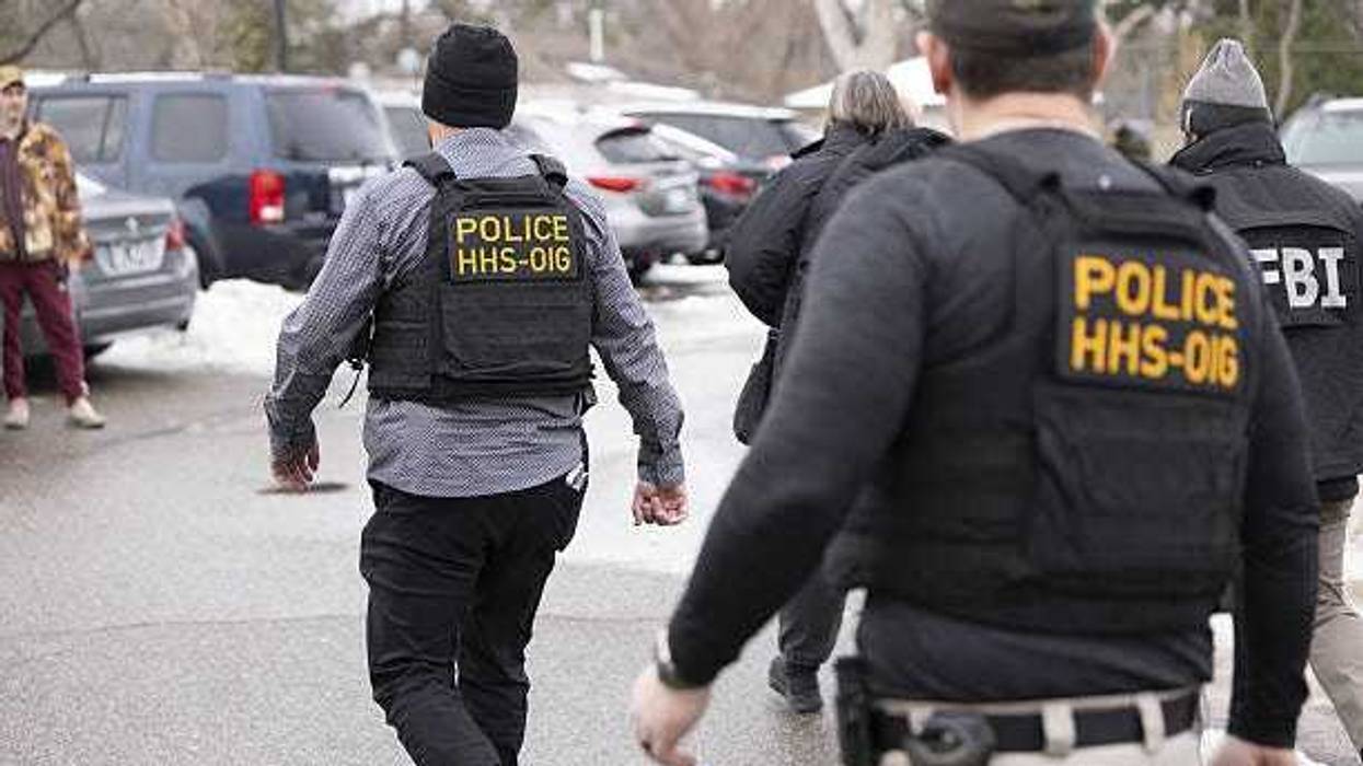 Federal agents walk through a parking lot after executing a search warrant at Ultimate Home Health Services as part of a potential Medicaid fraud investigation, on December 18, 2025 in Bloomington, Minnesota, United States.