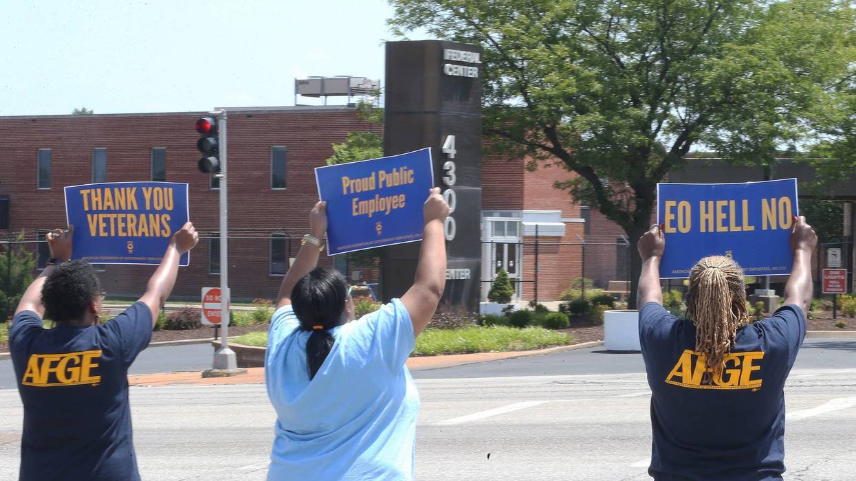 Federal workers hold signs and chant to passing cars outside of the Federal Center on Goodfellow Avenue on Saturday 27, 2019.