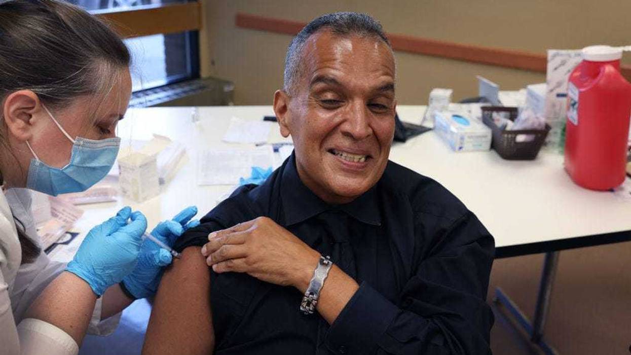 Felipe Sanchez gets a COVID-19 booster shot from pharmacist Patricia Pernal during an event hosted by the Chicago Department of Public Health at the Southwest Senior Center on September 09, 2022 in Chicago, Illinois.