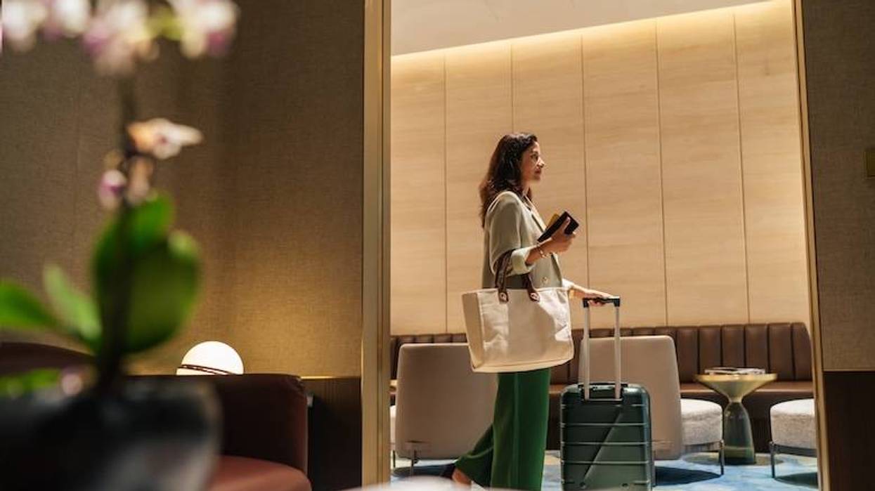 Female traveler with luggage in an airport lounge