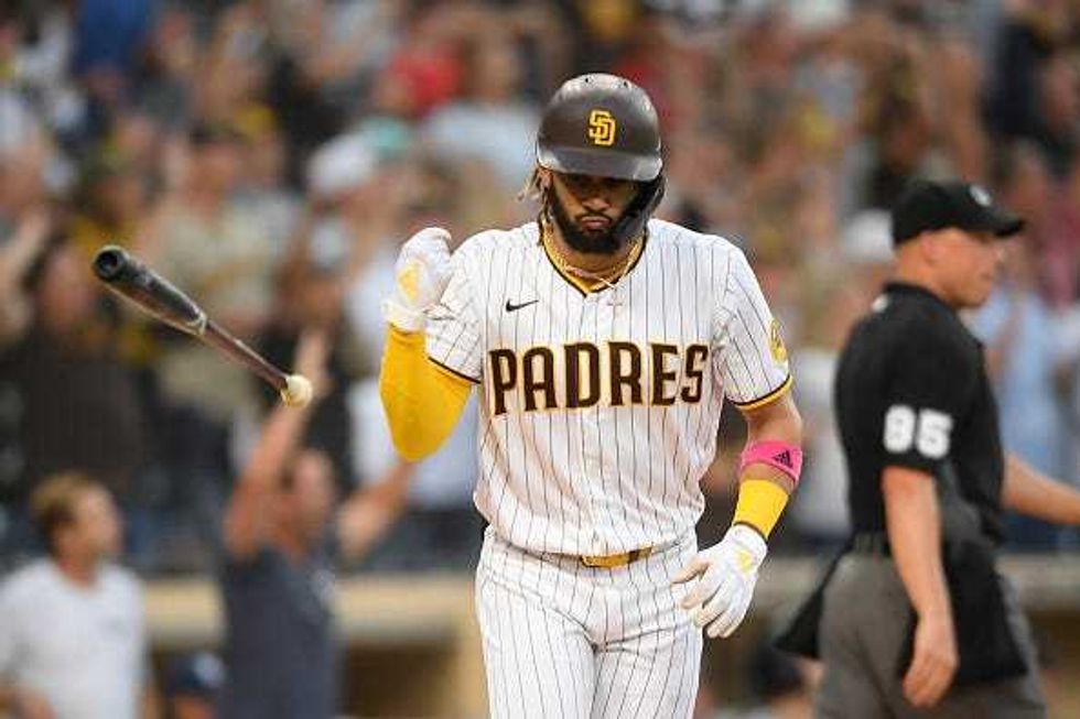 Fernando Tatis Jr flips his bat
