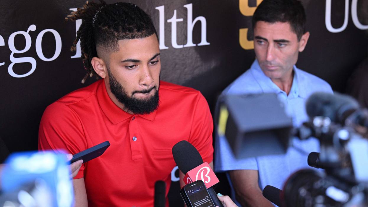Fernando Tatis Jr. (left) speak to the media alongside general manager A.J. Preller (right)
