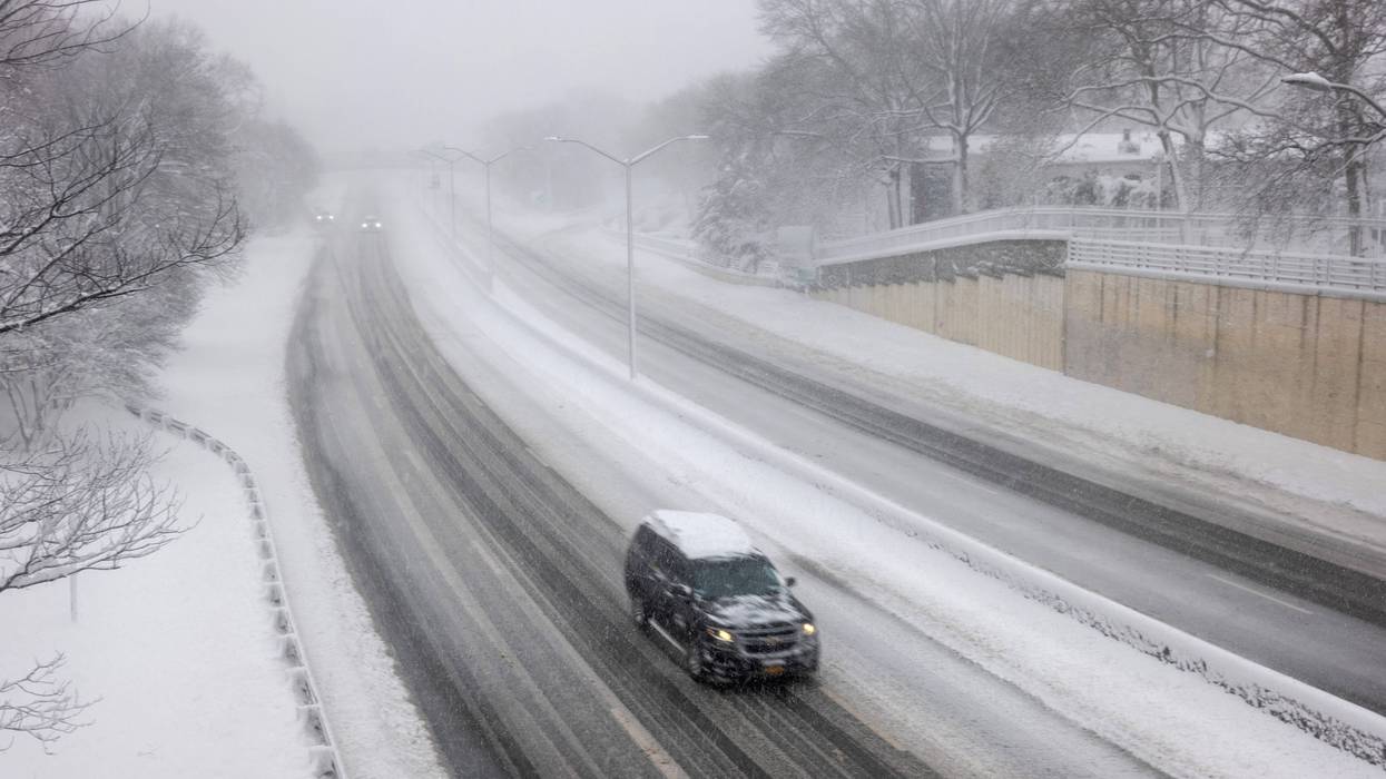 Few cars move along a Brooklyn highway as blizzard conditions continue in New York on Feb. 23