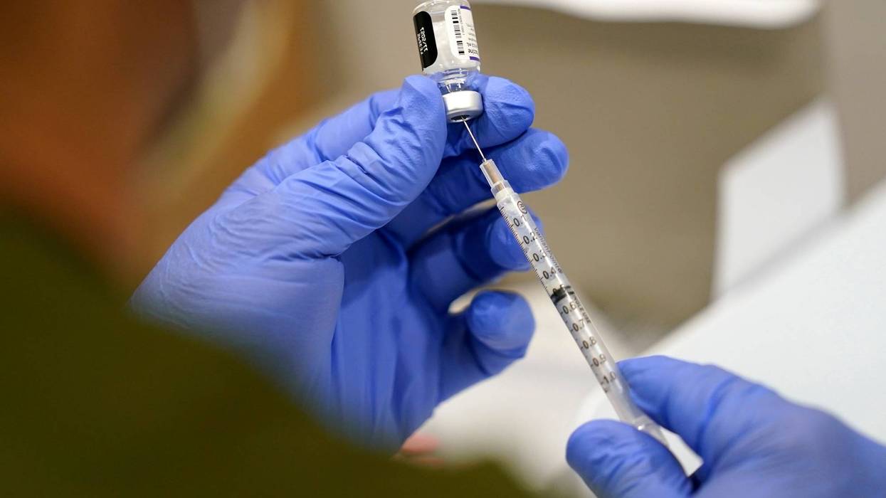 FILE - A healthcare worker fills a syringe with the Pfizer COVID-19 vaccine at Jackson Memorial Hospital on Oct. 5, 2021, in Miami.