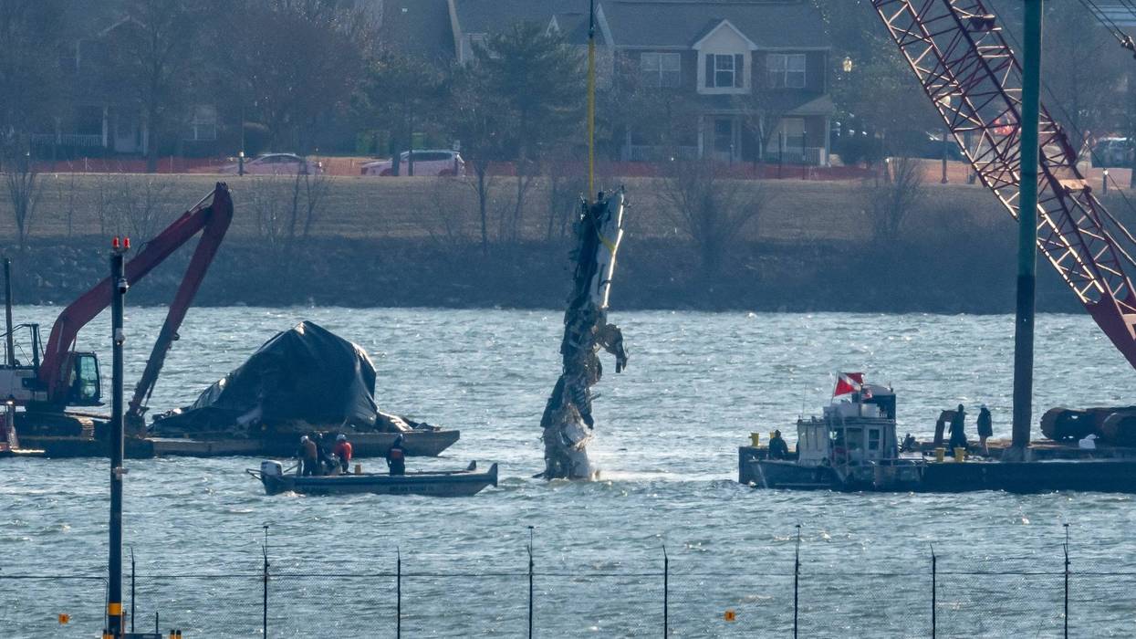 FILE - A piece of wreckage is lifted from the water onto a salvage vessel near the site in the Potomac River of a mid-air collision between an American Airlines jet and a Black Hawk helicopter, at Ronald Reagan Washington National Airport, Feb. 4, 2025, in Arlington, Va.