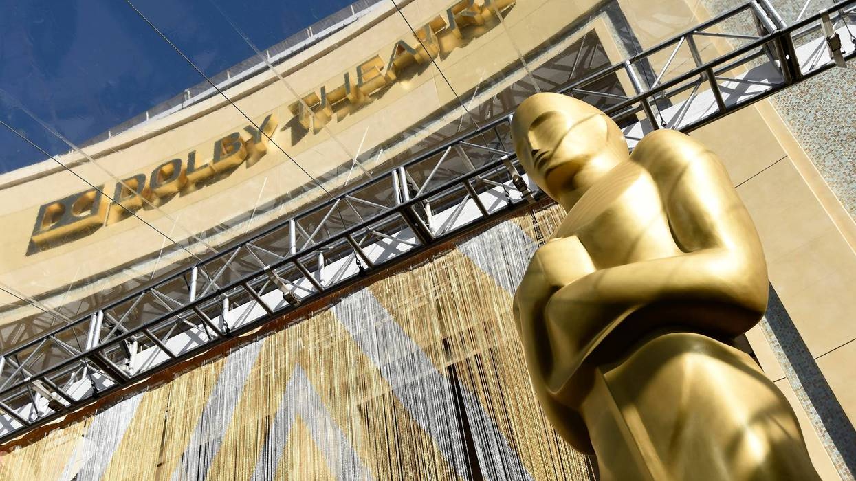 FILE - An Oscar statue is pictured underneath the entrance to the Dolby Theatre on Feb. 24, 2016, in Los Angeles. The Oscars will be held on Sunday, March 27 at the Dolby Theatre in Los Angeles. The ceremony is set to begin at 8 p.m. ET and will be broadcast live on ABC.