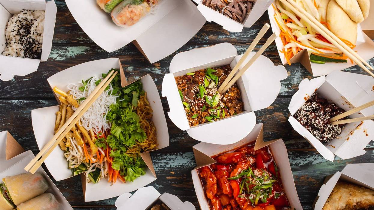 FILE - Assorted Chinese dishes in paper delivery boxes: sweet and sour chicken, dim sum, spring rolls, noodles, salad, rice, steamed buns, dips.