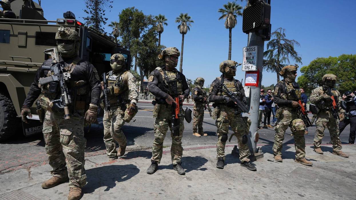 FILE - Federal agents stage at MacArthur Park, July 7, 2025, in Los Angeles.