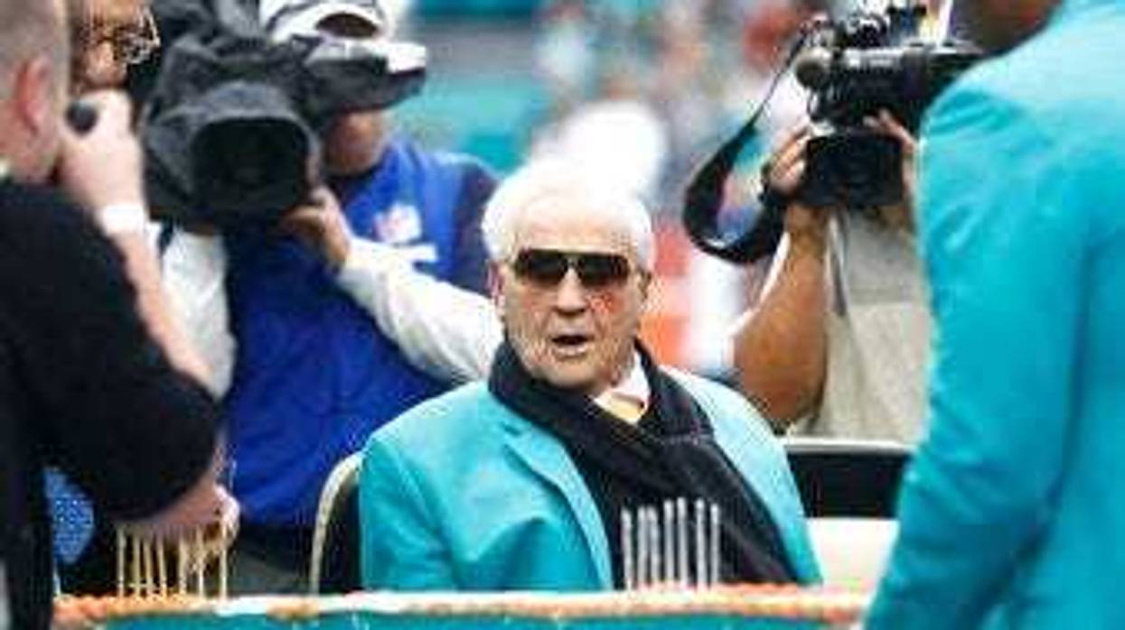 FILE - Former Miami Dolphins head coach Don Shula looks at a large cake celebrating the 1972 undefeated season and his birthday during half time at an NFL football game against the Cincinnati Bengals. (AP Photo/Brynn Anderson, File)