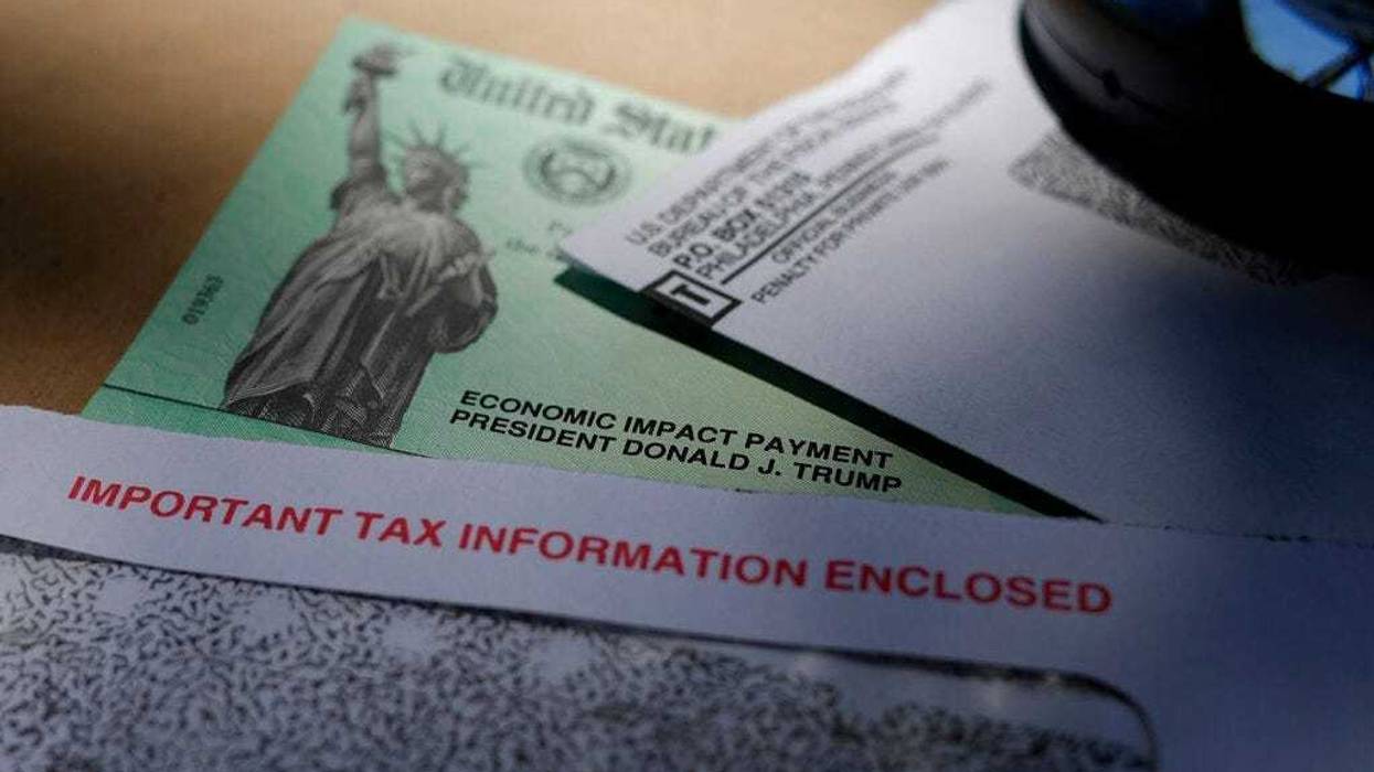 FILE - In this April 23, 2020, file photo, President Donald Trump's name is seen on a stimulus check issued by the IRS to help combat the adverse economic effects of the COVID-19 outbreak, in San Antonio.