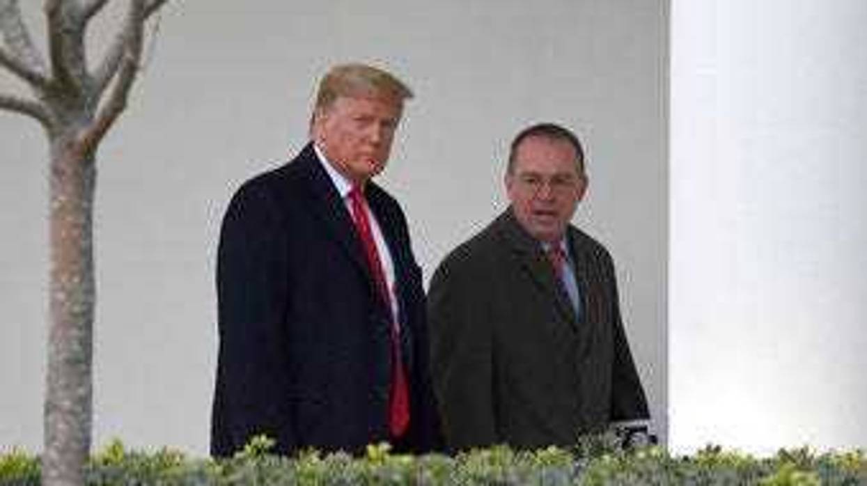 FILE - In this Jan. 13, 2020. file photo, President Donald Trump, left, and acting White House chief of staff Mick Mulvaney, right, walk along the colonnade of the White House in Washington. (AP Photo/Susan Walsh, File)