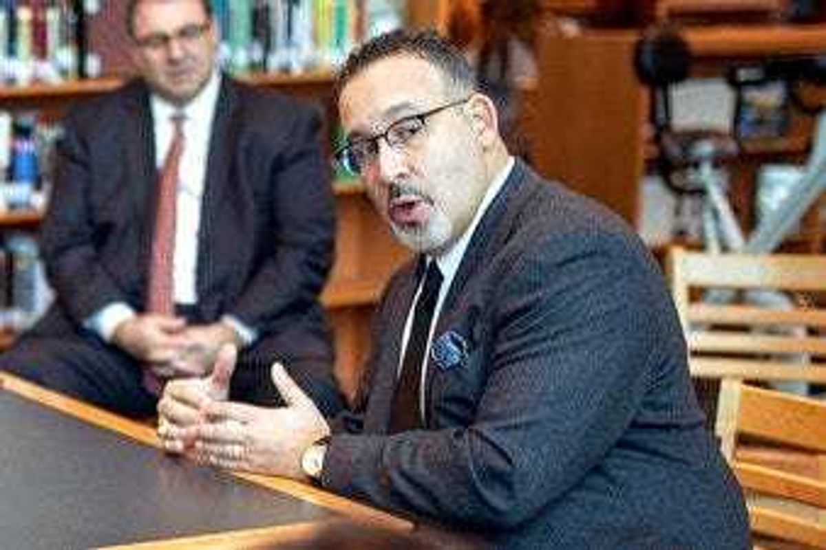 FILE - In this Jan. 28, 2020 file photo, Connecticut State Commissioner of Education Miguel Cardona speaks with Berlin High School students while on a tour of the school. (Devin Leith-Yessian/Berlin Citizen/Record-Journal via AP)