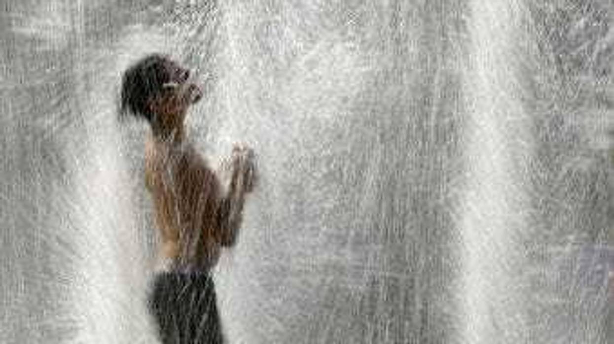 FILE - In this July 18, 2019, file photo, a boy plays in a fountain to cool off as temperatures approach 100 degrees Fahrenheit (38 Celsius) in Kansas City, Mo. (AP Photo/Charlie Riedel, File)