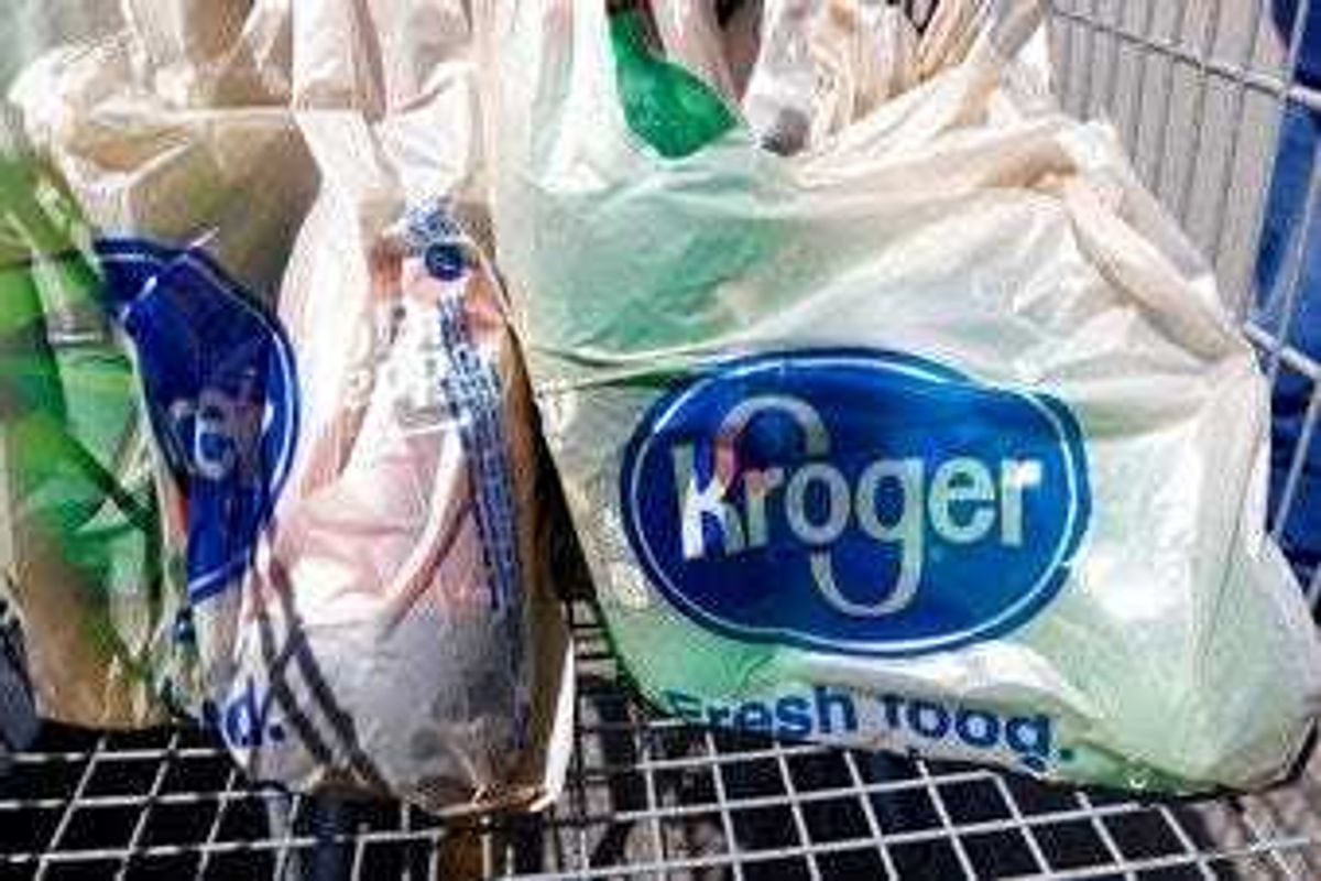 FILE - In this June 15, 2017, file photo, bagged purchases from the Kroger grocery store in Flowood, Miss., sit inside this shopping cart. (AP Photo/Rogelio V. Solis, File)