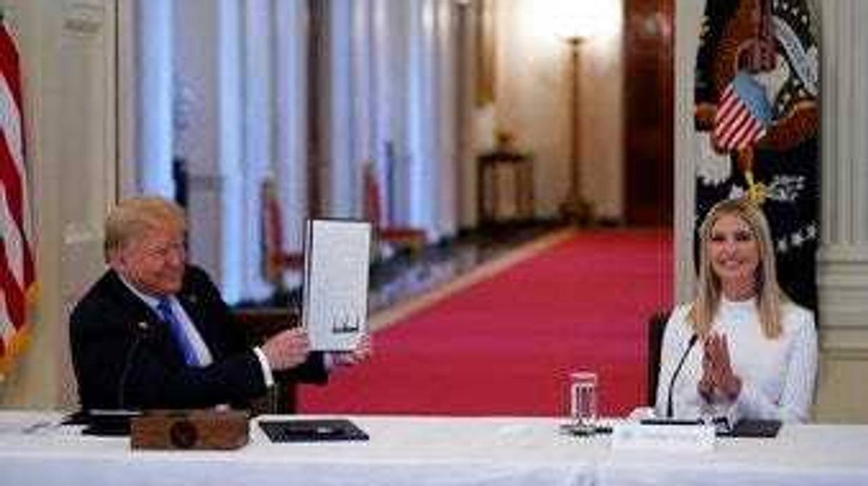 FILE - In this June 26, 2020, file photo, Ivanka Trump, right, applauds as President Donald Trump holds an executive order that he signed during a meeting with the American Workforce Policy Advisory Board. (AP Photo/Evan Vucci, File)