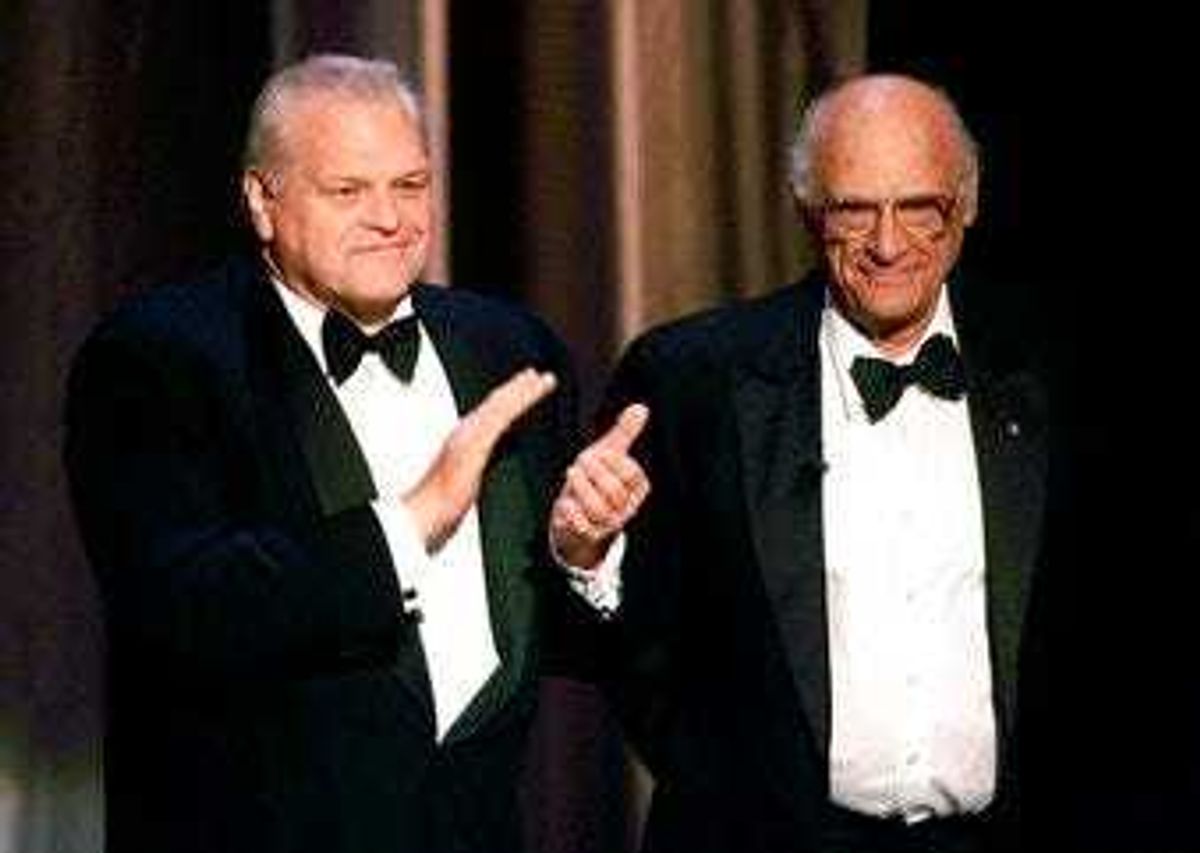 FILE - In this June 6, 1999 file photo, actor Brian Dennehy, left, applauds playwright, Arthur Miller, before awarding him the Lifetime Achievement Award at the Tony Awards in New York. (AP Photo/Kathy Willens, File)
