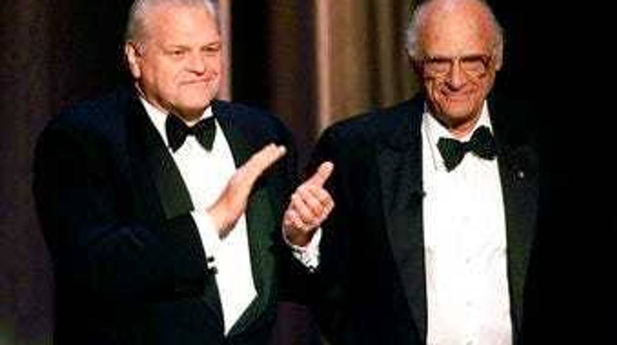 FILE - In this June 6, 1999 file photo, actor Brian Dennehy, left, applauds playwright, Arthur Miller, before awarding him the Lifetime Achievement Award at the Tony Awards in New York. (AP Photo/Kathy Willens, File)