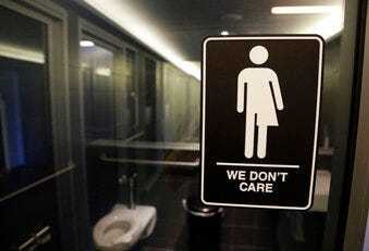 FILE - In this May 12, 2016, file photo, gender free sign hangs outside a restroom at 21c Museum Hotel in Durham, N.C. (AP Photo/Gerry Broome, File)