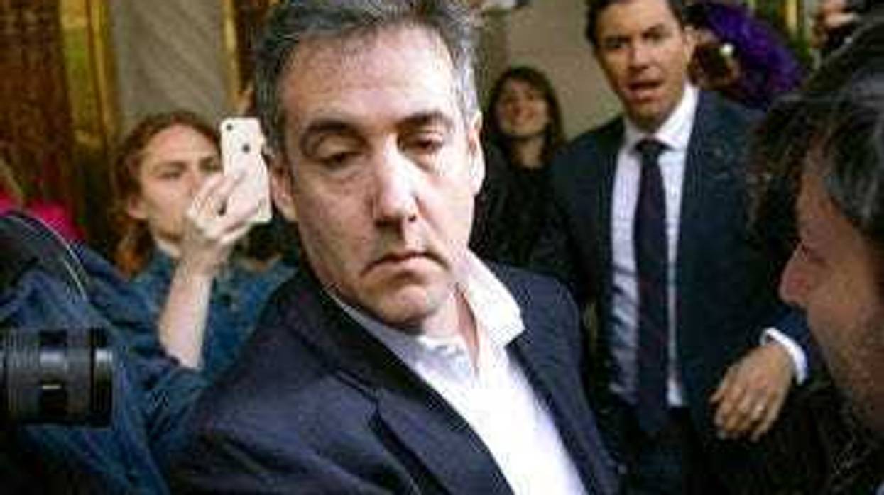 FILE - In this May 6, 2019, file photo, Michael Cohen, former attorney to President Donald Trump, leaves his apartment building before beginning his prison term in New York. (AP Photo/Kevin Hagen, File)