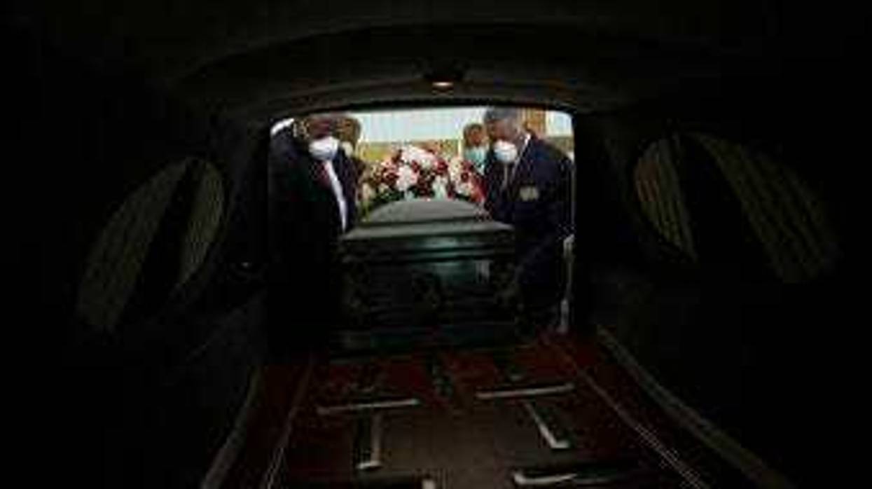 FILE - In this Saturday, April 18, 2020 file photo, a casket is placed into a hearse. (AP Photo/Brynn Anderson)
