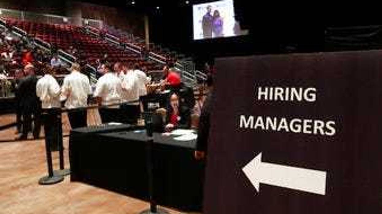 FILE - In this Sept. 18, 2019, file photo job applicants looks at jobs available at Florida International University during a job fair in Miami. (AP Photo/Lynne Sladky, File)