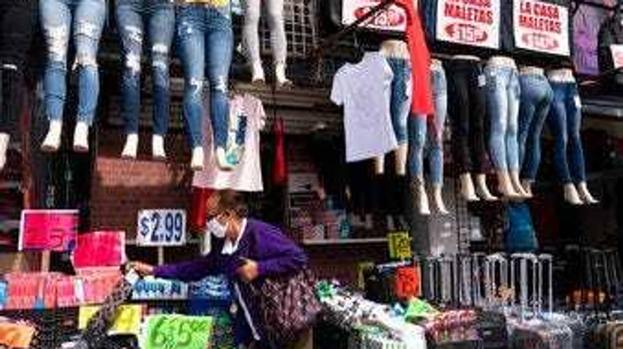 FILE - In this Sept. 25, 2020 file photo, a woman shops at a clothing store in New York. (AP Photo/Mark Lennihan, File)