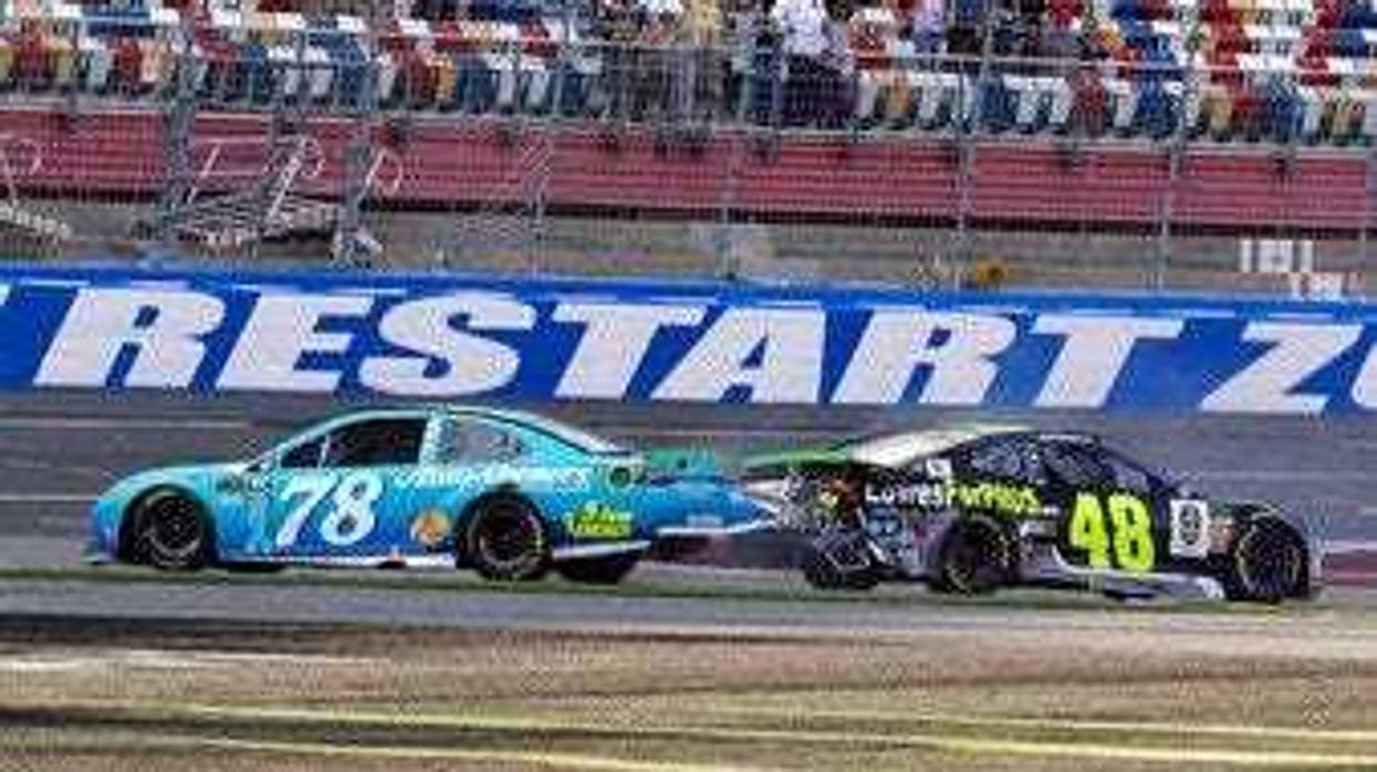 FILE - In this Sept. 30, 2018, file photo, Martin Truex Jr., (78) and Jimmie Johnson (48) crash on the final lap during the NASCAR Cup series auto race at Charlotte Motor Speedway in Concord, N.C.(AP Photo/Chuck Burton, File)