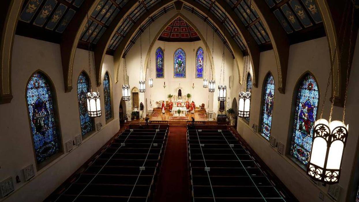 FILE - In this Sunday, April 5, 2020, file photo, The Most Rev. Peter Jugis, Bishop of Charlotte, conducts Palm Sunday services inside the empty St. Patrick Cathedral in Charlotte, N.C. Due to the coronavirus pandemic, the service was closed to the public but was live streamed across western North Carolina. Catholic entities in the Charlotte Diocese received more than $8 million in paycheck program aid.