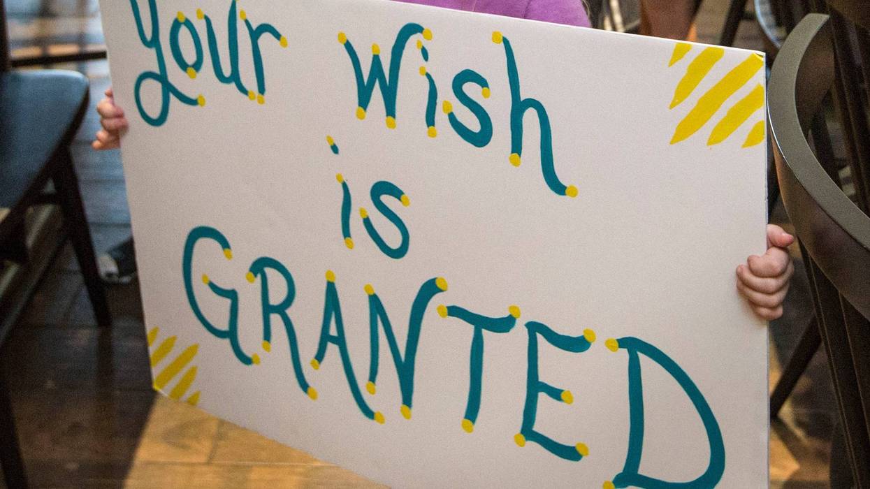 FILE - In this Thursday, Aug. 22, 2019 photo, a girl holds a sign while waiting for her cousin to arrive for a surprise Make-A-Wish announcement in Rogers, Ark. In June 2021, the Make-a-Wish Foundation is disputing what it calls a “misinformation” campaign about whether children who aren't vaccinated against COVID-19 will be eligible to have their wishes granted. (Ben Goff/The Northwest Arkansas Democrat-Gazette via AP)