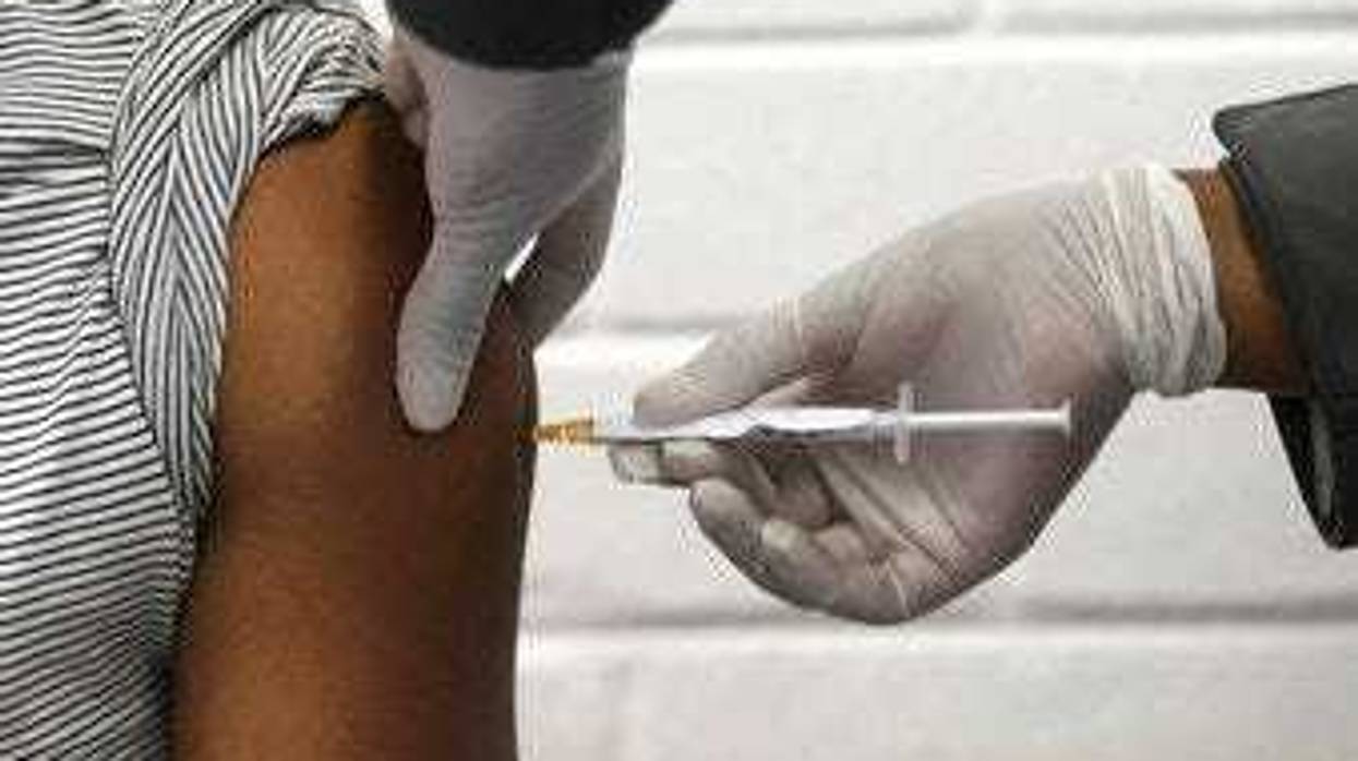 FILE - In this Wednesday, June 24, 2020 file photo, a volunteer receives an injection at the Chris Hani Baragwanath hospital in Soweto, Johannesburg, as part of Africa's first participation in a COVID-19 vaccine trial. (Siphiwe Sibeko/Pool via AP)