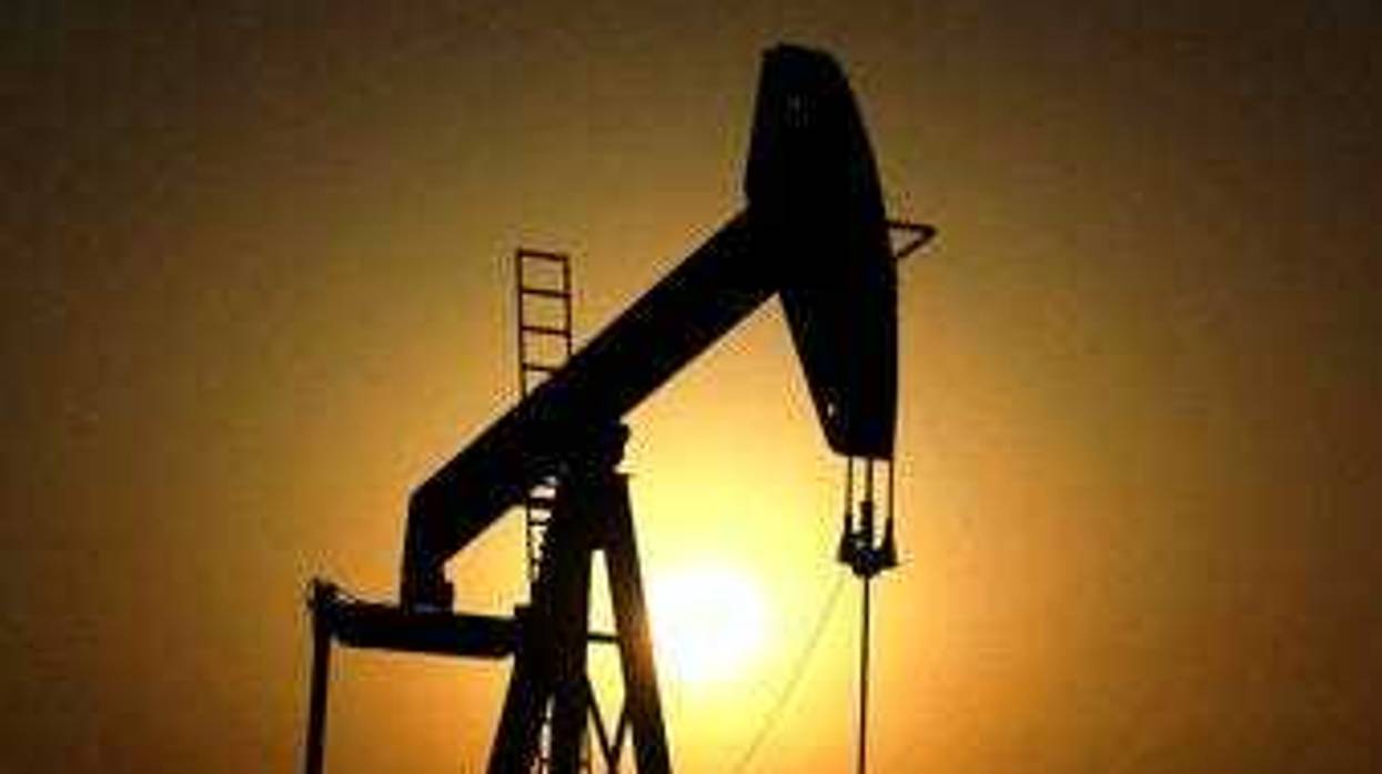 FILE- In this Wednesday, June 8, 2011 file photo, sun sets behind an oil pump in the desert oil fields of Sakhir, Bahrain. The global benchmark for crude oil rose above $70 a barrel on Monday. (AP Photo/Hasan Jamali, File)
