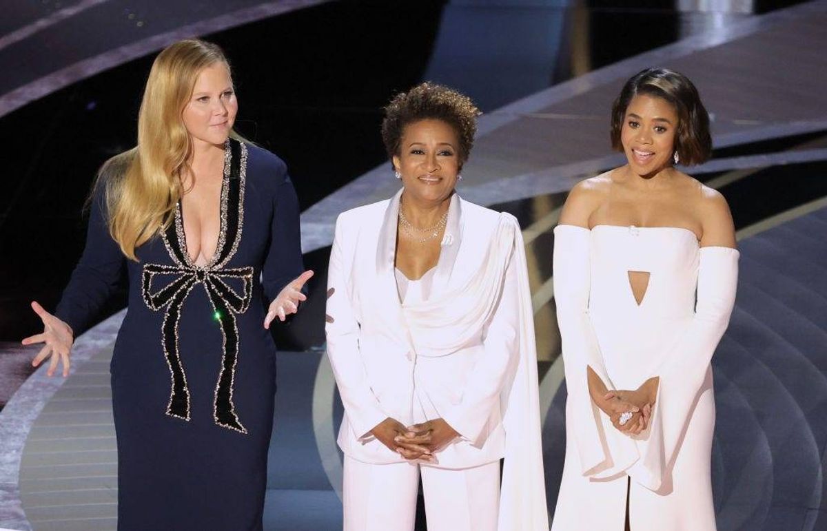 FILE - (L-R) Co-hosts Amy Schumer, Wanda Sykes, and Regina Hall speak onstage during the 94th Annual Academy Awards at Dolby Theatre on March 27, 2022 in Los Angeles.
