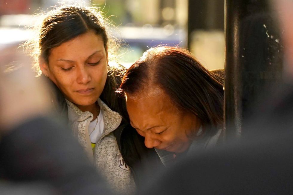 FILE - Leticia Harris, left, the wife of mass shooting victim Sergio Harris, consoles his mother, Pamela Harris after receiving the news of his death In Sacramento, Calif. April 3, 2022. Authorities are searching for at least one suspect in connection to the fatal shooting early Sunday morning.