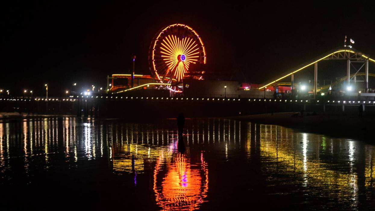 FILE: Lights of the Santa Monica Pier at night reflected on the beach and ocean.