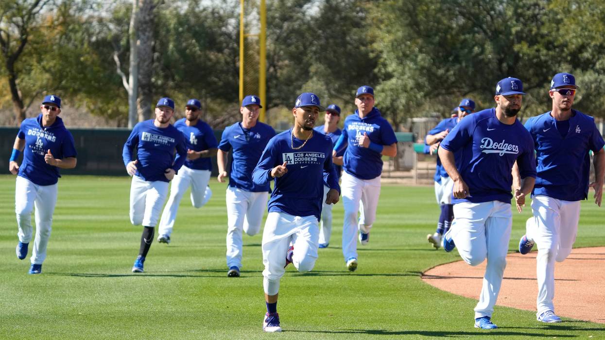 FILE - Los Angeles Dodgers outfielders Mookie Betts (front, left) leads drills on March 15, 2022 during spring training camp at Camelback Ranch in Glendale, Ariz.