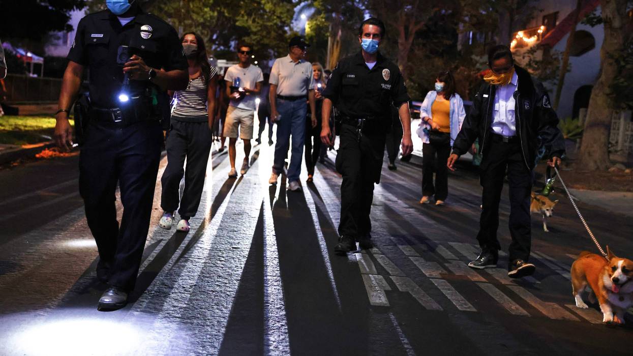 FILE: Los Angeles Police Department (LAPD) officers walk with community members during a National Night Out event hosted by Melrose Action on Aug. 3, 2021, in Los Angeles, California.
