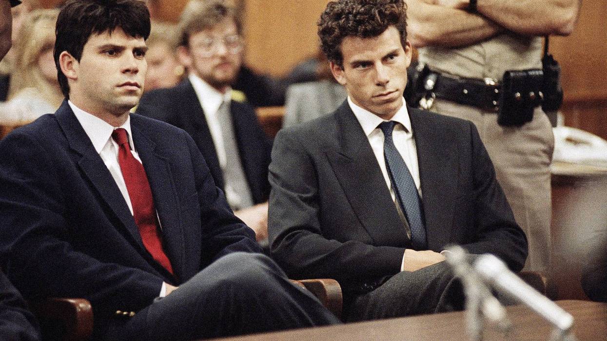FILE - Lyle, left, and Erik Menendez sit in Beverly Hills Municipal Court where their attorneys delayed making pleas on behalf of the brothers who are suspected in the murders of their parents on March 12, 1990.