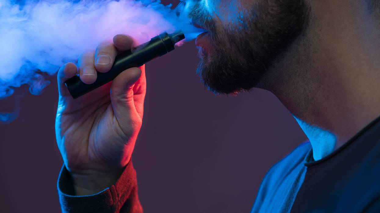 FILE: Man using vape pen.