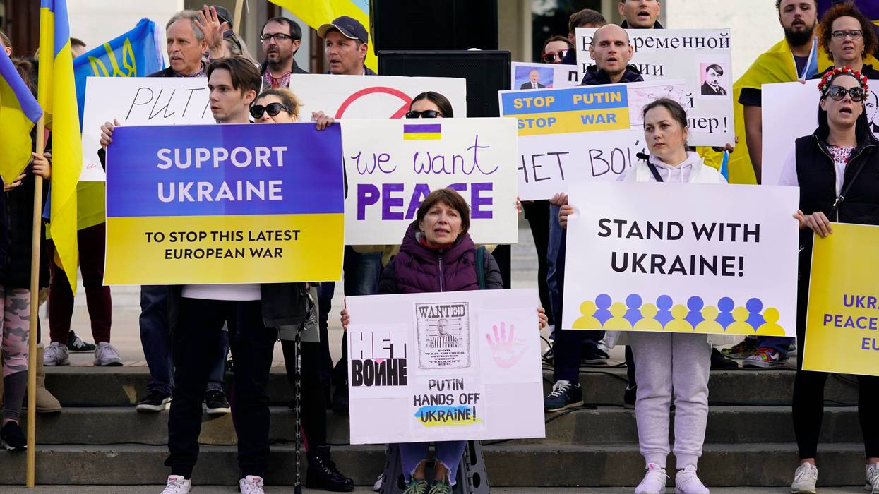 FILE— Members of the Ukrainian community and others gathered at the state Capitol to protest the Russian invasion of Ukraine at a rally n Sacramento, Calif., Thursday, Feb. 24, 2022. Roughly 18,000 Ukrainians live in the Sacramento region and the area is preparing for the possibility of many more Ukrainians arriving after U.S. President Joe Biden announced the nation will accept up to 100,000 refugees from the country.