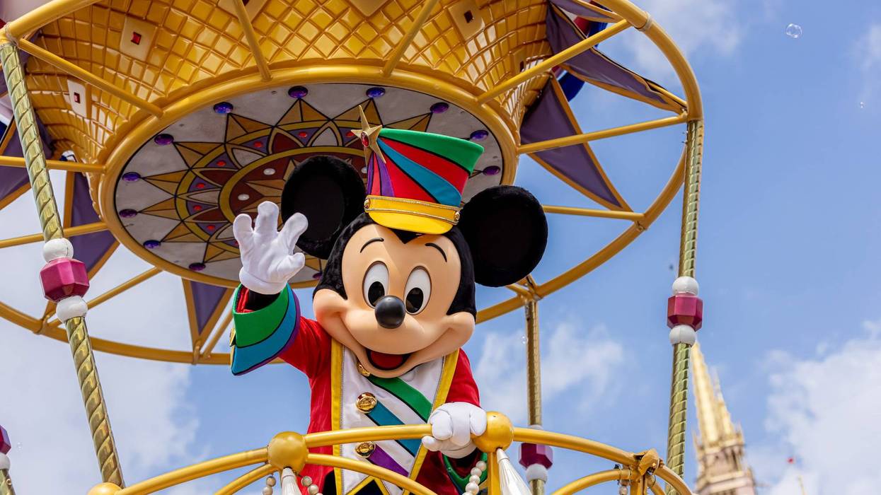FILE - Mickey Mouse waves to the crowd during the “Disney Festival of Fantasy Parade” in Magic Kingdom Park at Walt Disney World Resort in Lake Buena Vista, Fla. The parade returned to the park Wednesday, March 9, 2022, after a nearly two-year absence.