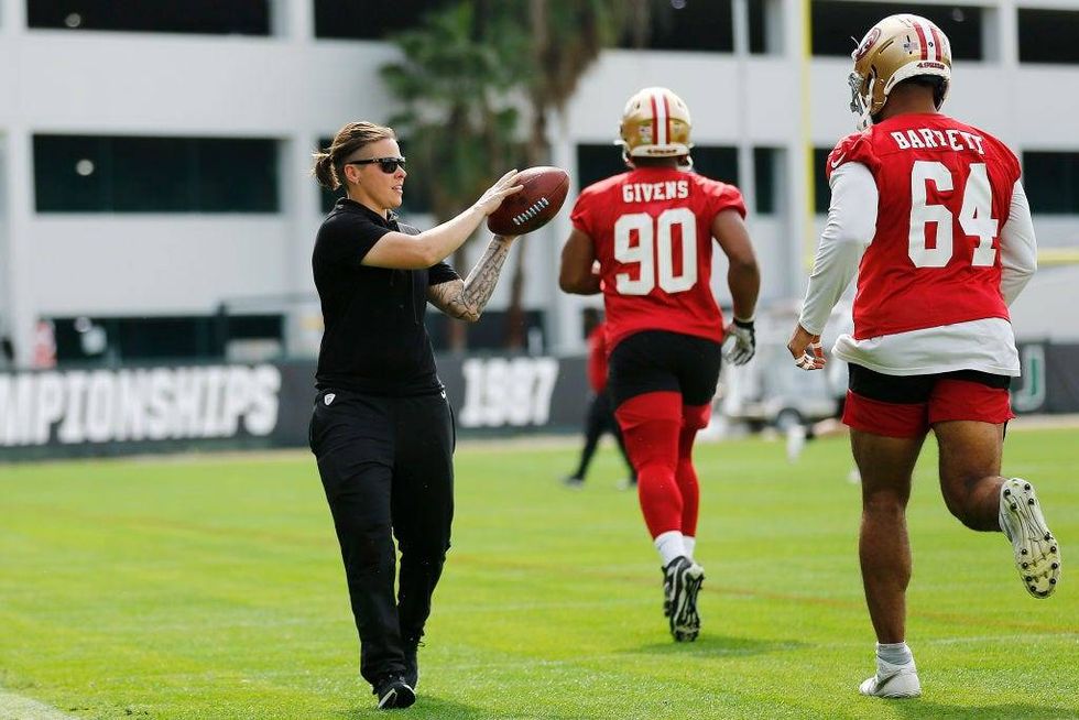 FILE - Offensive assistant coach Katie Sowers of the San Francisco 49ers runs a drill during practice for Super Bowl LIV at the Greentree Practice Fields on the campus of the University of Miami on Jan. 31, 2020 in Coral Gables, Florida.