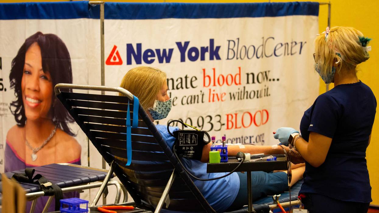 File photo: A donor specialist takes blood from a donor, at an emergency blood drive hosted by the New York Blood Center and the New York Islanders on World Blood Donor Day in Uniondale, New York, on June 14, 2021