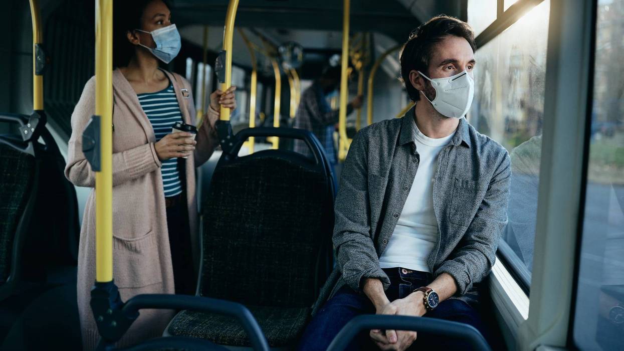 File photo of a man and woman wearing face masks on public transit during the coronavirus pandemic.