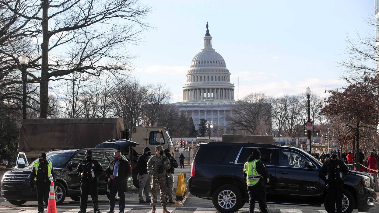 File photo: US National Guardsmen and police officers stand on a closed street outside the Capitol Building ahead of the inauguration