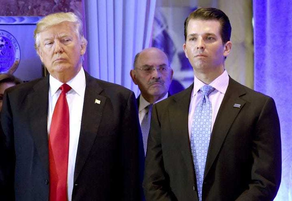 File photo: US President-elect Donald Trump along with his son Donald, Jr., arrive for a press conference at Trump Tower in New York, as Allen Weisselberg (C), chief financial officer of The Trump, looks on January 11, 2017