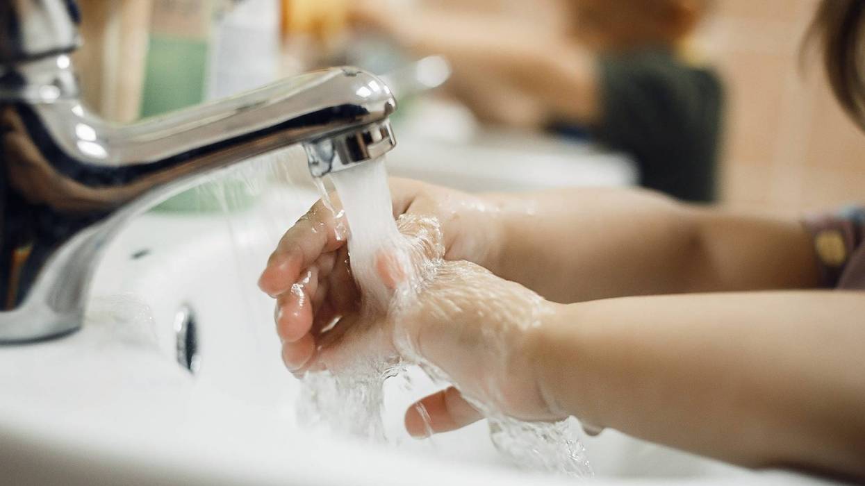 FILE: Schoolchild washing hands.