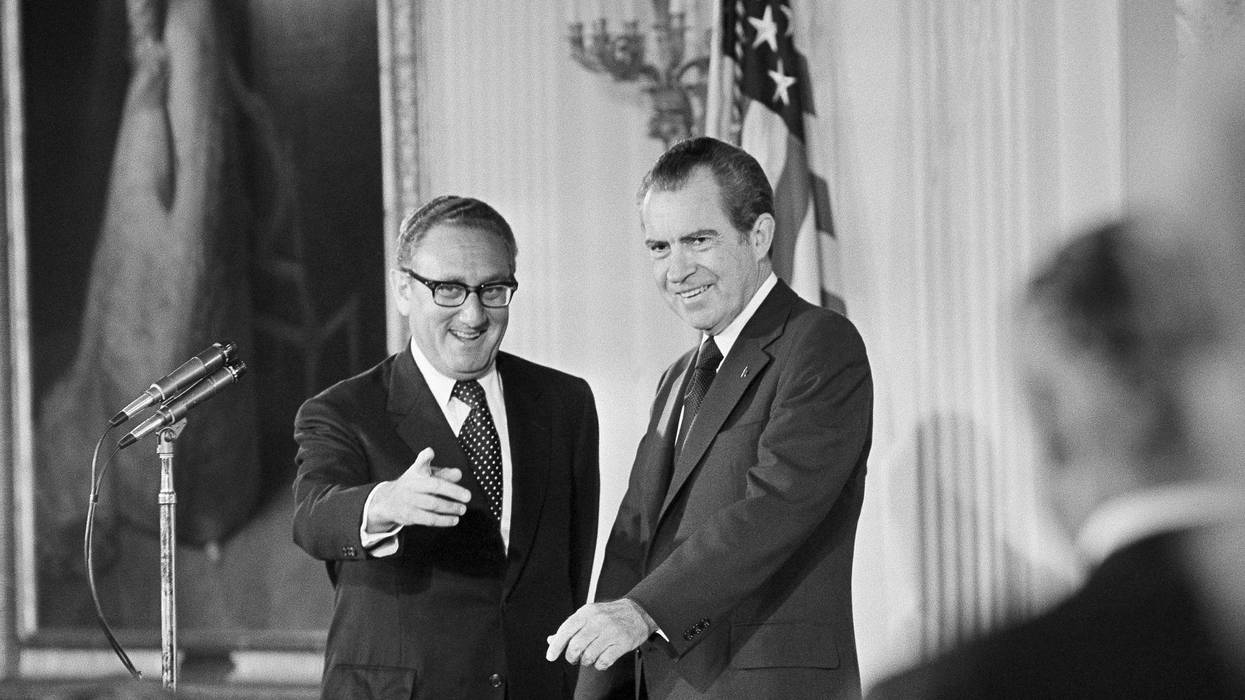 FILE - Secretary of State Henry Kissinger, left, gestures to the audience in the East Room of the White House, Sept. 22, 1973, as President Richard Nixon watches, in Washington. Kissinger had just been sworn in as the 56th secretary of state. Kissinger, the diplomat with the thick glasses and gravelly voice who dominated foreign policy as the United States extricated itself from Vietnam and broke down barriers with China, died Wednesday, Nov. 29, 2023. He was 100. (