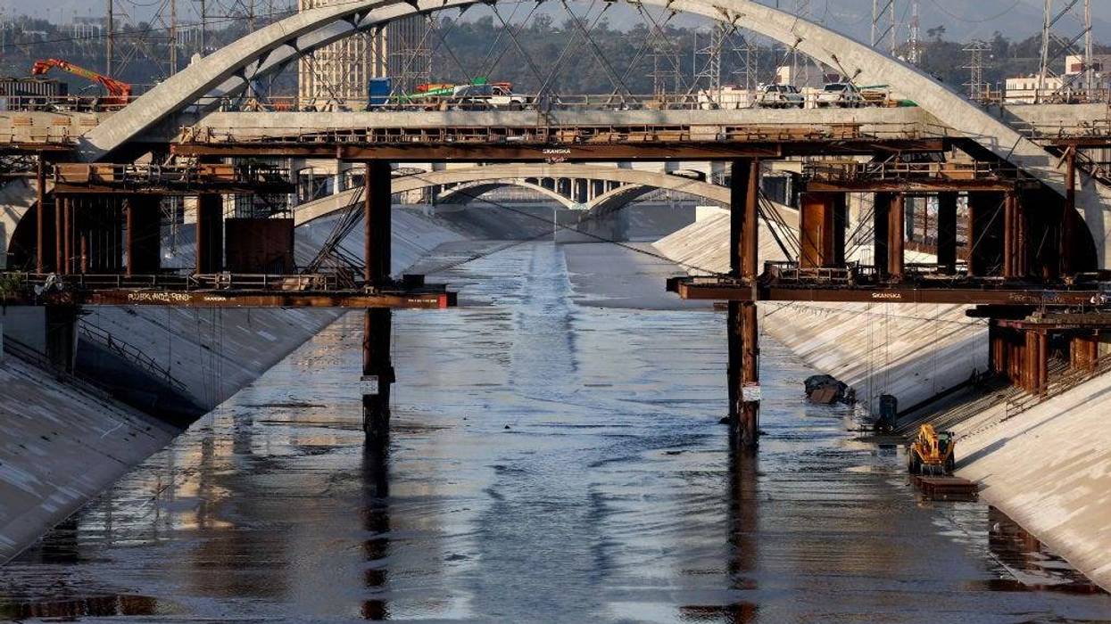FILE - The Los Angeles River flows beneath the Sixth Street Viaduct replacement project on Feb. 3, 2022 in Los Angeles. As climate change makes droughts more frequent and severe, concerns are growing among environmentalists that the 51-mile Los Angeles River could dry up. On most days of the year, 90% of the water flowing in the river has been discharged from wastewater treatment plants. Some cities along the river are aiming to increase wastewater recycling which would deprive the river of much of its water and threaten the river habitat.