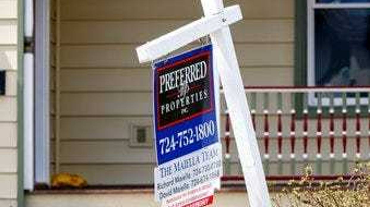 FILE This April 16, 2020 photo shows a real estate company sign marking a home for sale in Harmony, Pa. U.S. homeowners are seizing on historically low mortgage rates to refinance their mortgages. (AP Photo/Keith Srakocic)