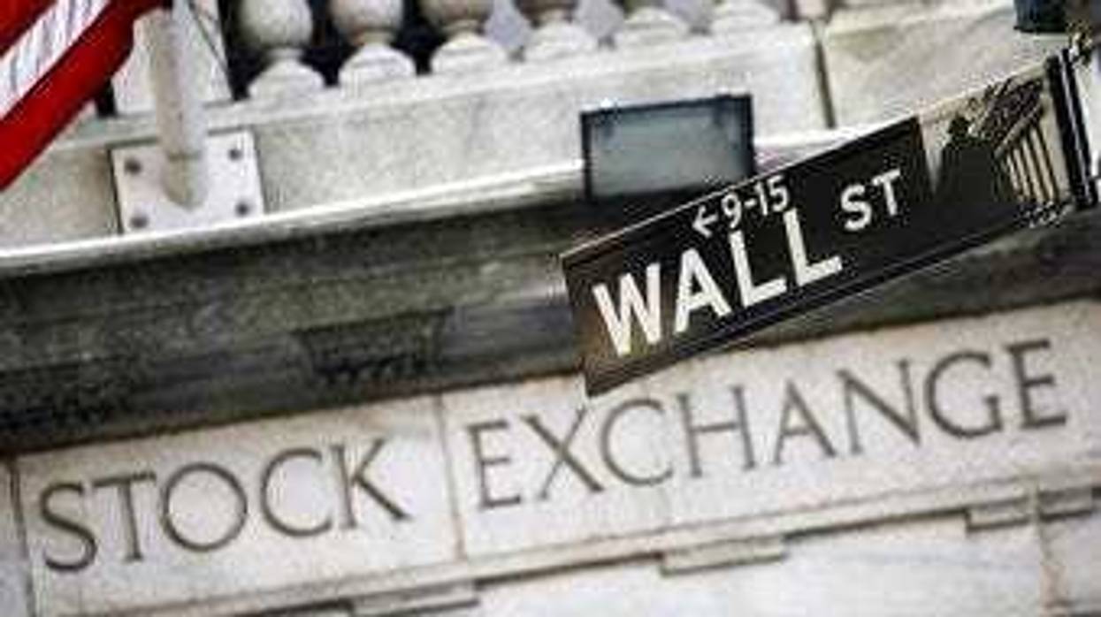 FILE - This July 16, 2013 file photo shows a street sign for Wall Street outside the New York Stock Exchange in New York. (AP Photo/Mark Lennihan, File)